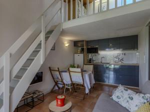 a living room with a staircase and a kitchen at Holiday Home Les Jardins de l'Océan-2 by Interhome in Pontaillac