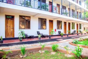 a building with chairs and tables in a courtyard at Explorers Hub in Kampala