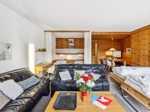 a living room with a couch and a table at Apartment Guardaval Apt 308 by Interhome in Davos