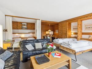 a living room with two beds and a couch at Apartment Guardaval Apt 308 by Interhome in Davos
