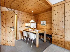 a dining room with a table and chairs at Apartment Guardaval Apt 308 by Interhome in Davos +43 photos