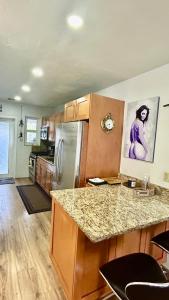 a kitchen with a counter top and a refrigerator at Llano Atelier in Miami