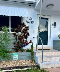 a front door of a house with a sign on it at Llano Atelier in Miami