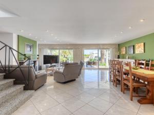 a living room with a staircase and a dining room at Holiday Home Llobregat 41b by Interhome in Empuriabrava