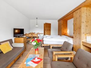 a living room with a bed and a couch at Apartment Guardaval Apt 107 by Interhome in Davos