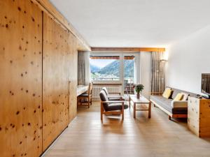 a living room with a large window and a couch at Apartment Guardaval Apt 107 by Interhome in Davos