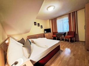 a hotel room with a bed and a table and chairs at Apartment Rosa-3 by Interhome in Mayrhofen