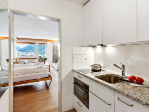 a kitchen with a sink and a bed in a room at Apartment Guardaval Apt 107 by Interhome in Davos