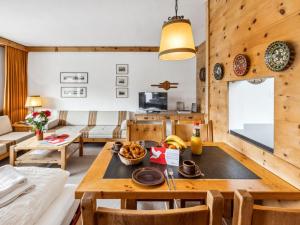 a kitchen and living room with a table and chairs at Apartment Guardaval Apt 202 by Interhome in Davos