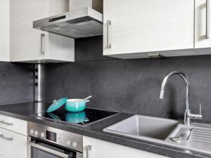 a kitchen with a sink and a counter top at Apartment Guardaval Apt 202 by Interhome in Davos