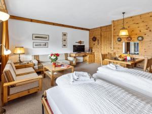 a hotel room with two beds and a living room at Apartment Guardaval Apt 202 by Interhome in Davos