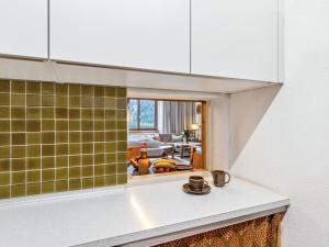 a kitchen with a counter top with a mirror at Apartment Guardaval Apt 508 by Interhome in Davos +42 photos