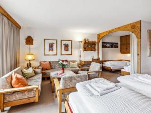 a living room with two beds and a couch at Apartment Guardaval Apt 508 by Interhome in Davos