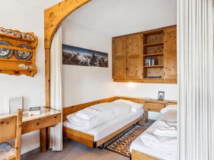 a bedroom with two beds and a mirror at Apartment Guardaval Apt 508 by Interhome in Davos