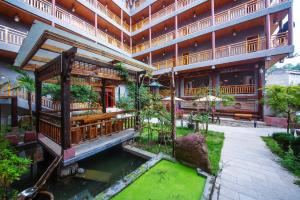 张家界Hongfu Villa - Zhangjiajie National Forest Park West Gate的享有带水池的建筑的外部景色