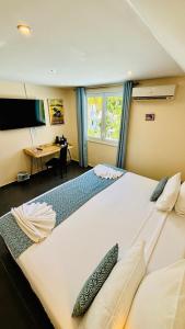 Postel nebo postele na pokoji v ubytování Hôtel Coco Island