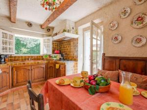 a kitchen with a table with a bowl of fruit on it at Holiday Home L'Oliverede by Interhome in La Garde-Freinet