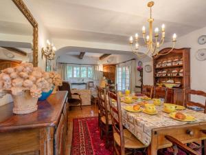 a dining room and living room with a table and chairs at Holiday Home L'Oliverede by Interhome in La Garde-Freinet
