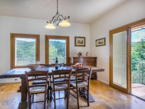 a dining room with a table and chairs and windows at Holiday Home Policleto by Interhome in Santo Stefano A Tizzano