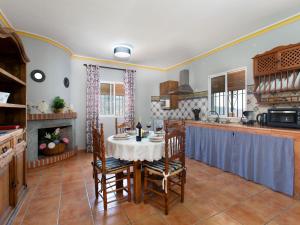 a kitchen and dining room with a table and chairs at Holiday Home Villa Montemar by Interhome in Torrox
