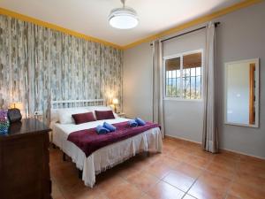 a bedroom with a bed and a large window at Holiday Home Villa Montemar by Interhome in Torrox +26 photos