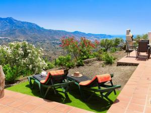 a patio with two chairs and a table with a view at Holiday Home Villa Montemar by Interhome in Torrox