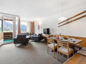 a living room with a table and chairs at Apartment Parkareal - Utoring-49 by Interhome in Davos
