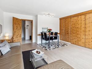 a living room with a couch and a table at Apartment Guardaval - Utoring-66 by Interhome in Davos