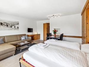 a living room with a bed and a couch at Apartment Guardaval - Utoring-66 by Interhome in Davos +50 photos