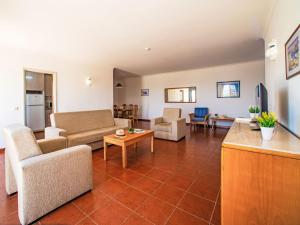 a living room with a couch and a table at Apartment Estrela do Vau Apart- 3 bedroom-3 by Interhome in Portimão
