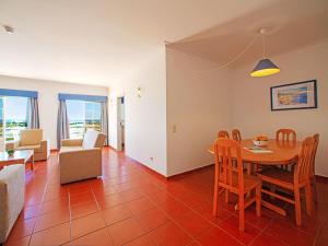 a living room with a table and chairs at Apartment Estrela do Vau-3 bedroom-3 by Interhome in Portimão