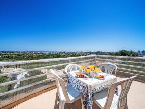 a table and chairs on a balcony with a view at Apartment Estrela do Vau Apart- 3 bedroom-3 by Interhome in Portimão