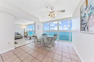 a dining room with a table and chairs and the ocean at Edgewater West Condos in Gulf Shores