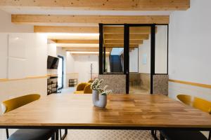 a dining room with a wooden table and chairs at Casa do Lagar in Paradela