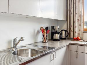 a kitchen with a sink and a counter top at Apartment Guardaval - Utoring-44 by Interhome in Davos +46 photos