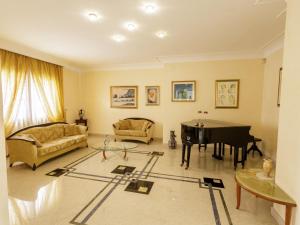 a living room with a table and a piano at Villa Incoronata by Interhome in Nardò