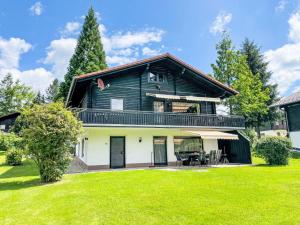 an exterior view of a house with a lawn at Holiday Home Am Hohen Bogen-49 by Interhome in Arrach