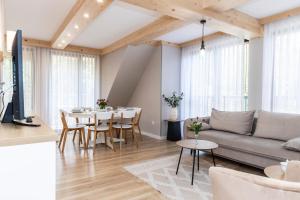 a living room with a couch and a table at TatryTop Apartamenty Sabała in Zakopane