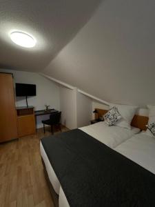 a hotel room with two beds and a flat screen tv at Hotel Restaurant Haus Odendahl in Cologne