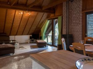 a living room with a table and some chairs at Holiday Home Eifelnatur - Haus 1-4 by Interhome in Immerath