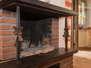 a brick fireplace with a cross on top of it at Holiday Home Eifelnatur - Haus 1-4 by Interhome in Immerath