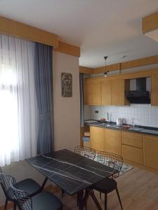 a kitchen with a table and chairs and a kitchen with a counter at Aydere Apart Hotel in Ayder Yaylasi