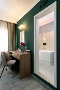 a bathroom with a desk with a mirror and a tub at Hotel Cocó in Timişoara +66 photos