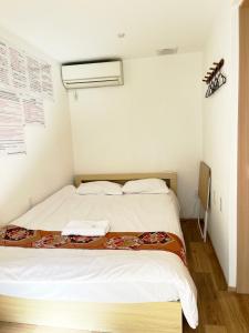 Postel nebo postele na pokoji v ubytování Hananosato Hotel 池袋本店