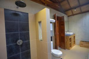 a bathroom with a shower with a toilet and a sink at Gili Air Lagoon Resort By Waringin Hospitality in Gili Islands