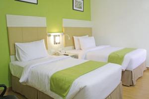 Postel nebo postele na pokoji v ubytování Hamersons Hotel Cebu
