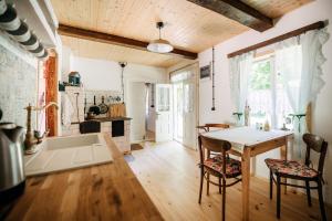 a kitchen and dining room with a table and chairs at Sielsko in Lipsko-Polesie
