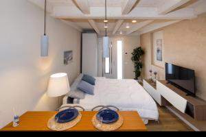 a bedroom with a bed and a table with a television at Sunshine Suite in Senigallia