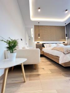 a bedroom with a bed and a couch and a table at Milan Boutique Villa in Paderno Dugnano +35 photos