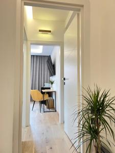a hallway with a table and a dining room at Milan Boutique Villa in Paderno Dugnano